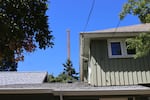 A crane working on the first phase of the Next Generation Housing Development Plan looms over a home in the Villard neighborhood on July 8, 2026.