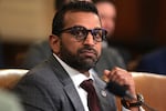 In this photo, FBI Director Kash Patel is photographed from about the shoulders up while seated in a chair. He's wearing a suit and tie, as well as glasses.