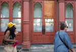 People walk past the vacant White Stag Building in Old Town Portland, Ore., during during No Vacancy’s guided art walk on Sept. 4, 2025. No Vacancy is a project that turns the windows of vacant buildings into exhibition venues for Portland artists, with the intent of boosting foot traffic and community engagement in the neighborhood. 