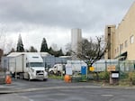 Trucks leave the Mondelez International bakery facility in Portland, Feb. 3, 2022. Workers say they're often forced to work overtime with inadequate notice.