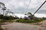 A downed power line and other damage from a tornado caused by Hurricane Milton is seen in Port St Lucie, Fla., on Thursday. The storm triggered some 126 tornado warnings in a short period of time, raising alarms about the impending large hurricane.