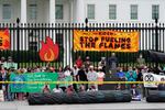 Protesters gather to call on the Biden administration to do more to combat climate change and ban fossil fuels outside the White House in Washington, on Tuesday, Oct. 12, 2021.