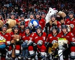 Players from the Portland Winterhawks pose with some of the over 14,787 donated stuffed animals at this year's Teddy Bear Toss game, Dec. 10, 2022.