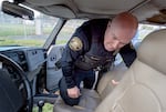 Officer Michael Terrett surveys the inside of a recently recovered stolen vehicle during a November 2024 mission. The Portland Police Bureau has been tracking more granular detail about stolen vehicles to improve their ability to find and catch them.