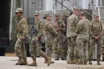 Military personnel in uniform, with the Texas National Guard patch on, are seen at the U.S. Army Reserve Center, Tuesday, Oct. 7, 2025, in Elwood, Ill., a suburb of Chicago.