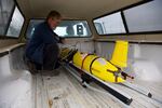 Scientists carefully carry the glider out to the research vessel.