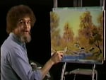 A screenshot from the premiere of "The Joy of Painting" shows the painter Bob Ross with the work, "A Walk in the Woods," which is up for sale.