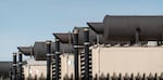 Generators and their exhaust pipes are visible outside of an Amazon data center in Umatilla, Ore., in April 2026.