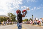 Legacee Medina of Macon, Ga. leads chanting at a No Kings rally between an elementary school and pickleball courts in Macon on October 18, 2025. The rally moved from its earlier location downtown to stay out of the way of a planned Hispanic festival.
