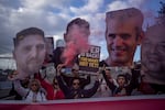 Relatives and supporters of Israelis held hostage in the Gaza Strip hold photos depicting their faces during a protest.