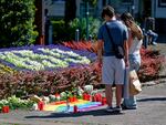 People observe a memorial Saturday near the scene of a knife attack in Solingen, Germany.