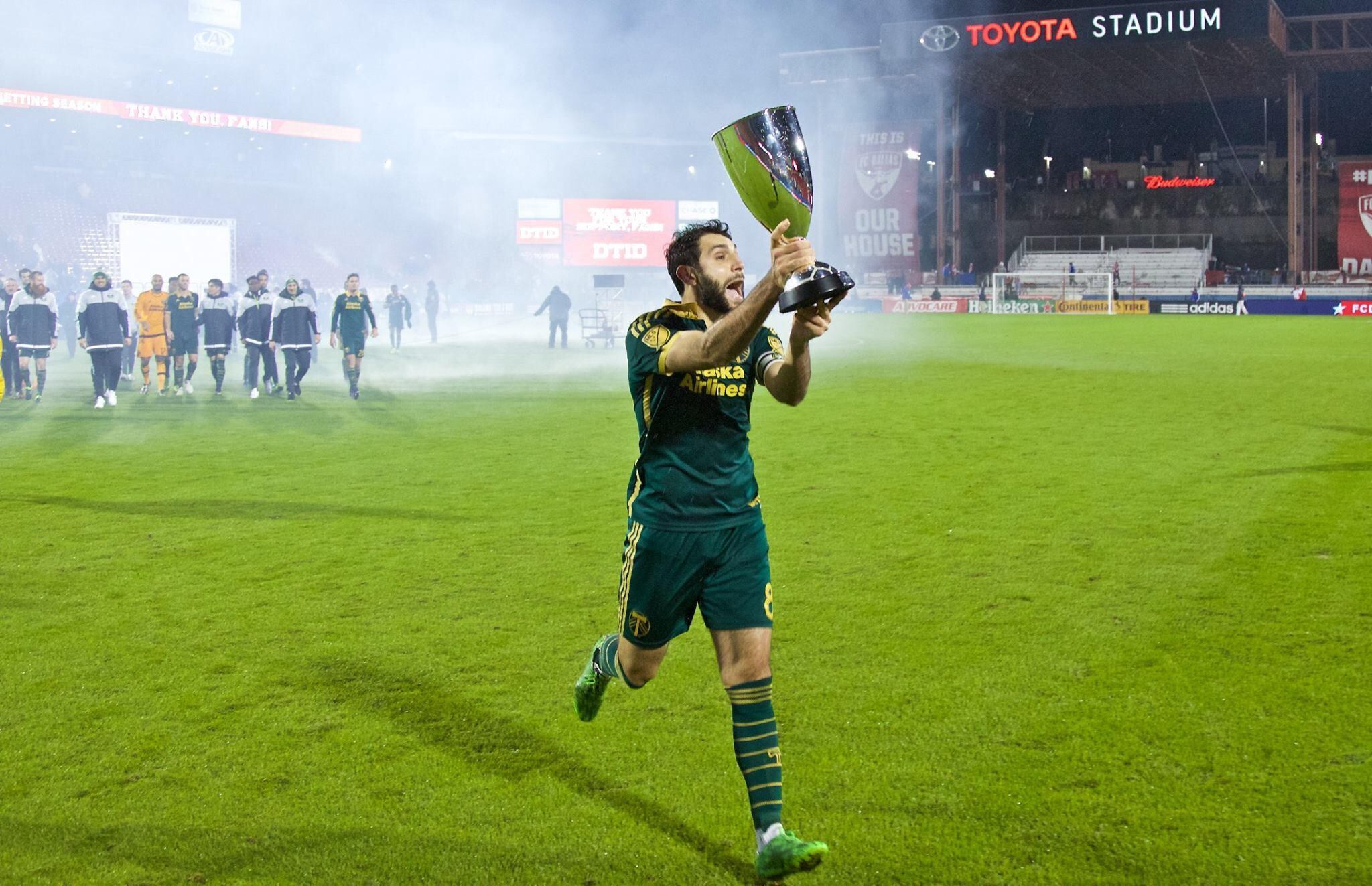 Portland Timbers midfielder Diego Valeri (8) carries the Western Conference Championship Trophy over to the Timbers Army at Toyota Stadium. Valeri is now an analyst and announcer for Spanish broadcasts on MLS Season Pass for Apple TV.