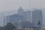 FILE: The downtown skyline in Portland, Ore., on Aug. 3, 2017, is obscured by a blanket of smoke from far away wildfires.