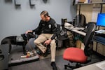 Officer Ben Costigan with the Gresham Police Department sits in his office with the department's new comfort dog Tagg on Dec. 23, 2019, in Gresham, Oregon.