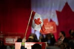 A supporter waves a Canadian flag during a campaign rally for Mark Carney, Canada's prime minister, in Calgary, Alberta, Canada, on Tuesday, April 8, 2025. Carney said Donald Trump's tariff policy is an act of economic self-sabotage that's pushing the US into a downturn. Photographer: Gavin John