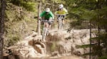 Mountain bikers ride Whistler's iconic A-line trail. The growth of mountain biking as a sport and the sucess of Whistler's flow trails has inspired Stevens Pass, Mt. Bachelor, and Timberline to pursue their own trails. 