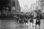 A black and white photo of Black female soldiers walking in a parade.