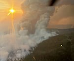 Smoke billows above the 208 Fire burning in the Willamette National Forest east of Eugene, Ore., in this handout photo from Sept. 5, 2024.