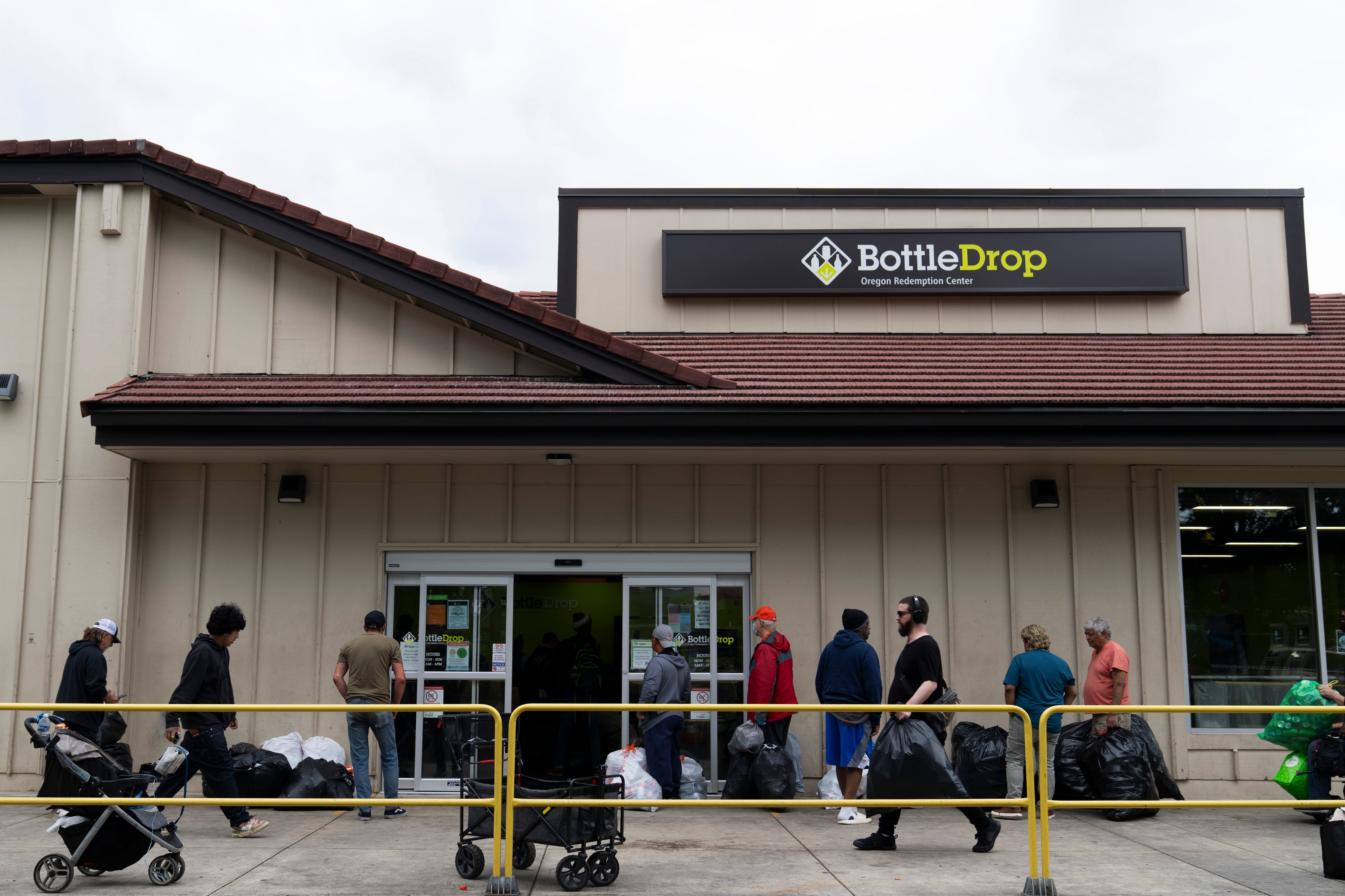 People wait in line outside the Glisan BottleDrop Redemption Center.