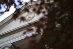 Melrose Hall at Linfield College is seen through Japanese maple leaves Tuesday, May 21, 2019, in McMinnville, Ore. Budget cuts and declining enrollment have forced tough decisions about the future of small, private colleges like Linfield.