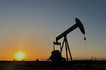 FILE - The sun sets as a pump jack operates near Loving, N.M., on Tuesday, May 20, 2025.