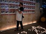 A man holds his baby as he looks at posters of the men, women and children held hostage by Hamas in the Gaza Strip, during a vigil marking 30 days since the Oct. 7 Hamas attack that started the fighting, in Jerusalem, Israel Sunday, Nov. 5, 2023.