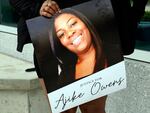 A protester holds a poster of Ajike Owens and demands the arrest of a woman who killed her during a rally at the Marion County Courthouse, June 6, 2023, in Ocala, Fla.