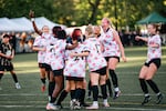FILE - In this provided photo from May 2026, players for the Portland Cherry Bombs FC, a pre-professional women’s soccer team in the USL W League, celebrate playing in one of the team's first games in its inaugural season. The team consists of players in high school, college and graduates seeking an opportunity to play, and the Cherry Bombs play home games in Lents Park.