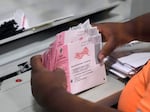 An election worker prepares mail ballots at the Clark County Election Department on Nov. 8, 2022, in Las Vegas. The Republican National Committee and the Trump campaign have filed a federal lawsuit seeking to prevent Nevada from counting mail ballots received after Election Day, as state law permits.