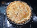 An apple pie fresh from the oven rests on a cooling rack on October 22, 2023. OPB's Crystal Ligori baked the pie using the recipe created for the state of Vermont from Stacey Mei Yan Fong's book, "50 pies 50 states. An immigrant's love letter to the United States through pie."