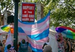 Attendees of the Portland Trans Pride March move to cover a Christian protestor's sign in a large trans pride flag in Old Town Portland, Ore., July 20, 2024. Anti-LGBTQ+ demonstrations take place at Pride parades across Oregon, especially in the Clackamas County area where Hoodview News is distributed.