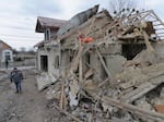 A villager passes by debris of private houses ruined in a Russian attack in a village in Zolochevsky district in the Lviv region, Ukraine, on Thursday. Ukrainian forces said the Russian barrage included the use of hypersonic missiles.