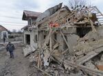 A villager passes by debris of private houses ruined in a Russian attack in a village in Zolochevsky district in the Lviv region, Ukraine, on Thursday. Ukrainian forces said the Russian barrage included the use of hypersonic missiles.