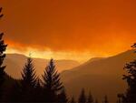 Smoke turns the morning light orange on Saturday in this photo taken near the Huckleberry Lookout, provided by the Cedar Creek Fire Incident Command.