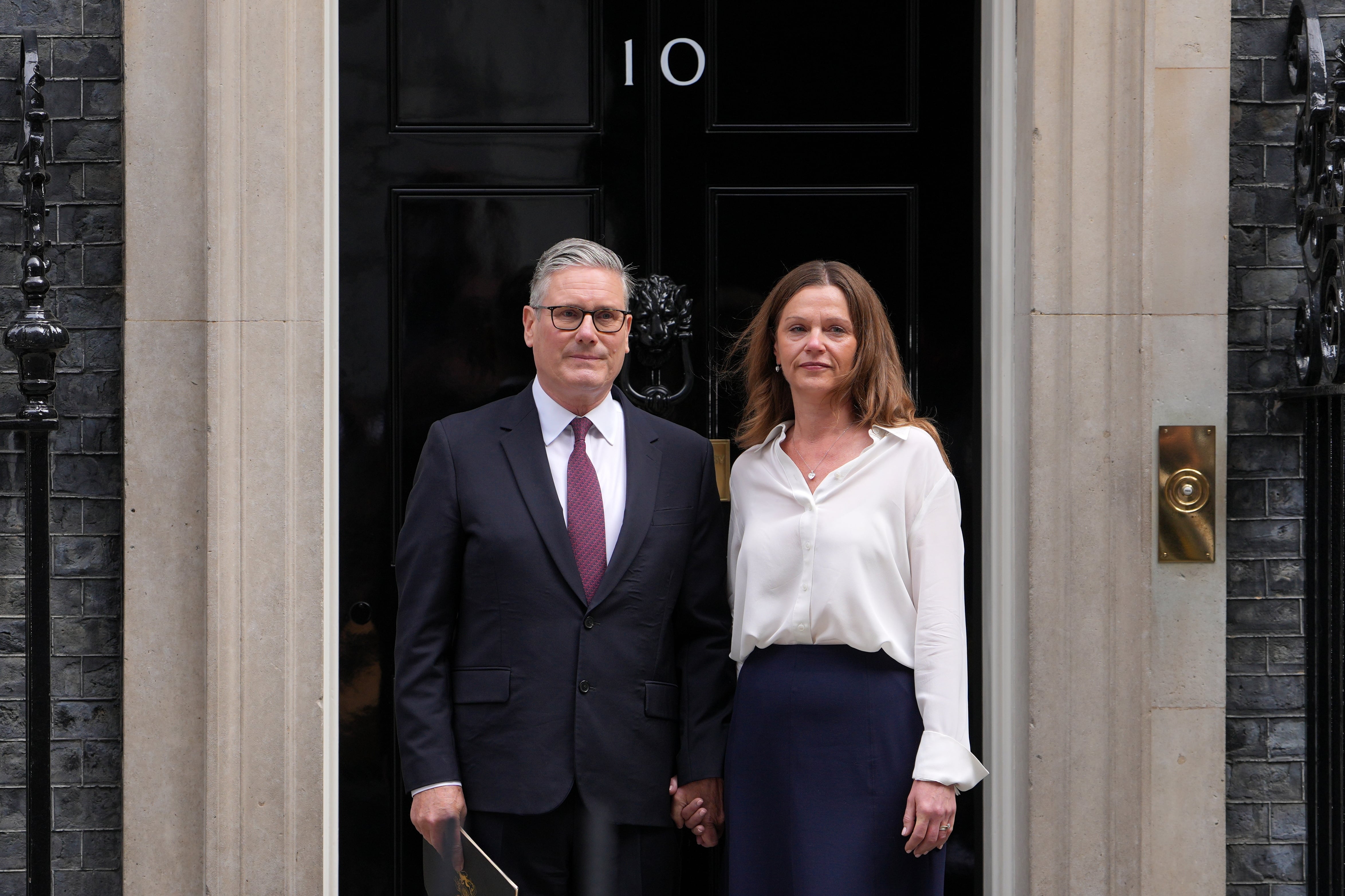 Britain's Prime Minister Keir Starmer and wife Victoria stand in front of 10 Downing Street door after speaking to the media in London, Monday, June 22, 2026.
