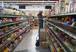 Employee Jorge Méndez stocks shelves with imported ramen products at Fubonn Supermarket inside Fubonn Shopping Center in Portland, Ore., on April 28, 2026.