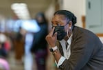 Prescott Principal Nichole Watson reminds a student to pull their mask up as she greets students in line for lunch.