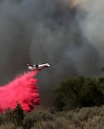 In this photo provided by InciWeb, a plane drops retardant on the Durkee Fire on Sunday, July 21, 2024.