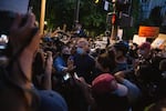 Mayor Ted Wheeler moves through a crowd of people at a protest in Portland, Ore., July 22, 2020. People have protested police brutality and systemic racism for nearly two months straight and have called on the mayor to resign.