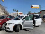 A member of the Mexican security forces stands next to a white minivan with North Carolina plates and several bullet holes at the scene of the crime in Matamoros on Friday.