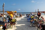Vendors hawking food and flotation devices wait for visitors at Lido beach in Mogadishu on Nov. 10, 2025. 