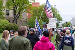 A handful of anti-abortion activists wave flags and signs and chant at a rally in Boise, Idaho.