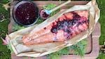Cooked salmon with blackberry jam on top