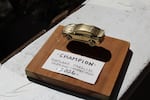 The 2026 Portland Parallel Parking Competition grand prize, a gold spray-painted miniature Subaru glued to a wood slab, sits on Daniel Lyman's balcony in Southeast Portland, Ore., Aug. 30, 2026.