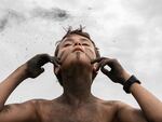 Arturo paints his face with campfire ashes at a nature immersion camp in Italy.