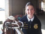 Madison Love, vice president of the Crater FFA chapter in Central Point, Oregon, poses for a photo with her goat, Rasputia, at the Oregon State Fair in Salem on Aug. 22, 2025.