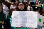 A young person holds a sign decrying gun violence at an abortion rights rally in Union Square in New York City on Thursday.