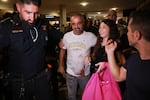 Israeli passenger Yaniv Hayoun, with blood stains on his shirt, who was aboard a Flydubai aircraft that made an emergency landing in Saudi Arabia, is welcomed at the arrivals gate at Ben Gurion International Airport near Tel Aviv, Israel, Wednesday, Sept. 30, 2026.
