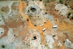 This aerial view shows an open mine shaft where artisanal miners get access to the mine in Stilfontein, South Africa, where there are believed to be hundreds of clandestine miners at a disused mining shaft struggling to survive in grim conditions because of a police operation to force them out.