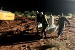 Workers bury the bodies of victims of recent flooding caused by Mediterranean storm Daniel near the city of Derna, Libya, late Tuesday, Sept. 12.